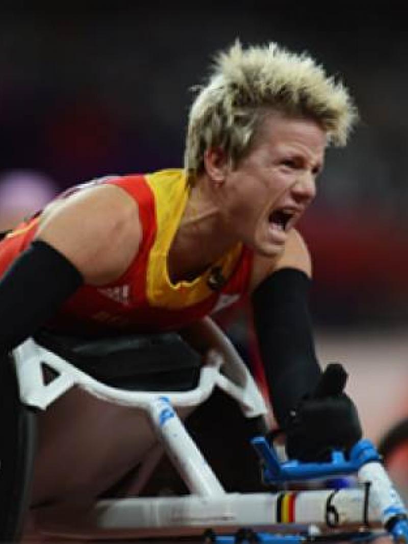 A picture of a woman in a wheelchair screaming after her victory in an athletics race