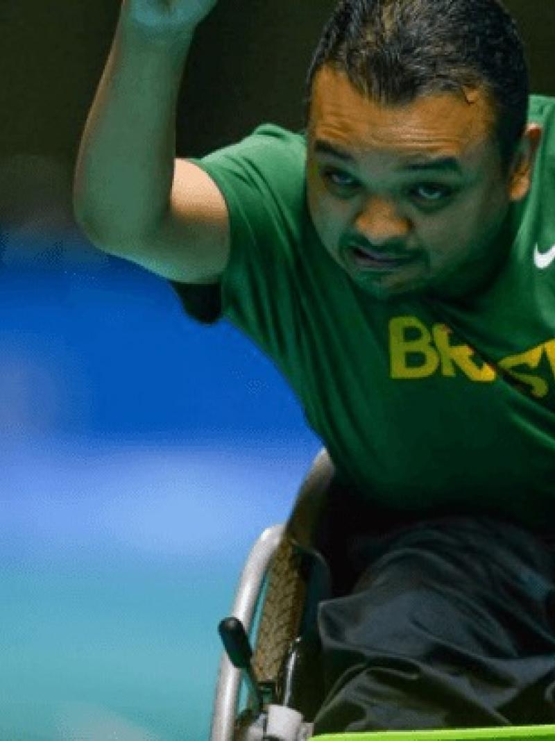 Man in wheelchair throwing a boccia ball