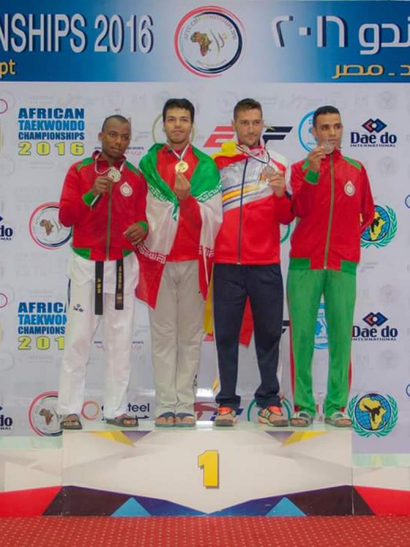 Four men stand on the podium