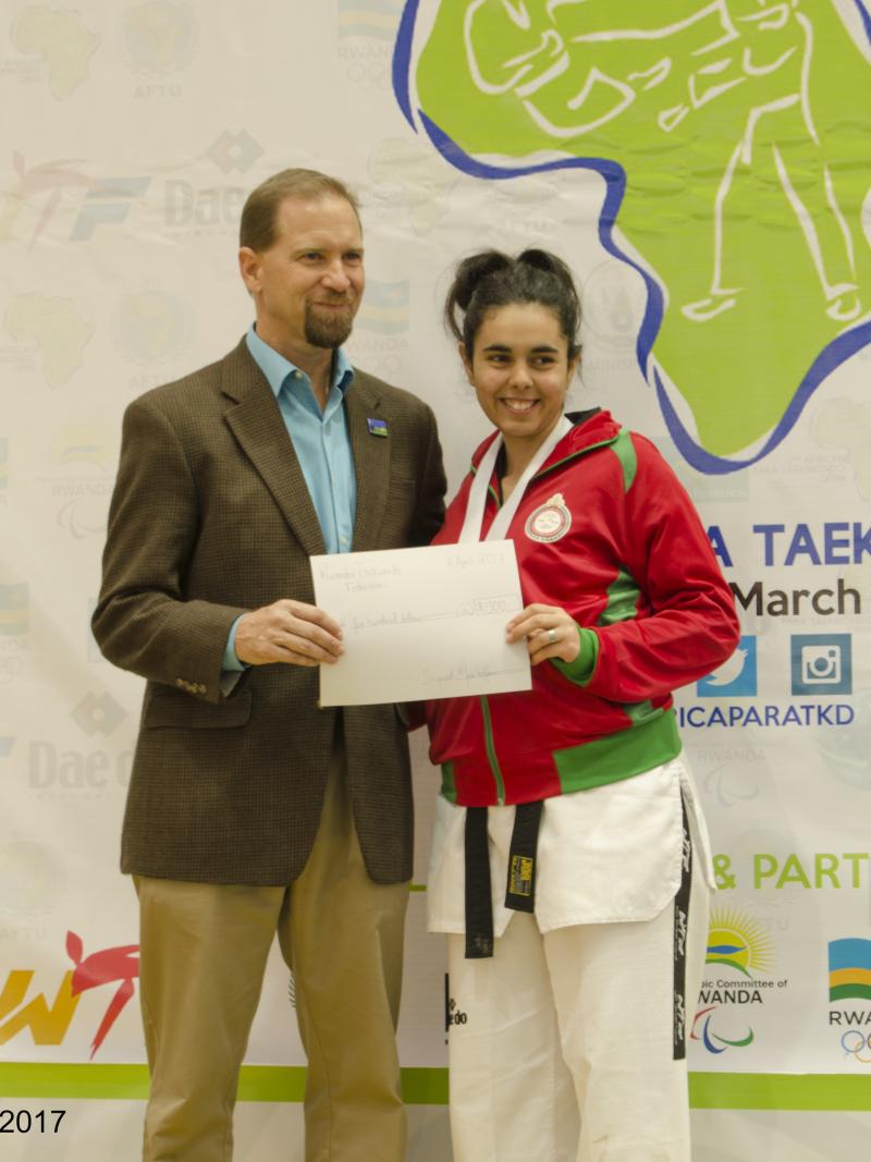 Woman holds sign with a man