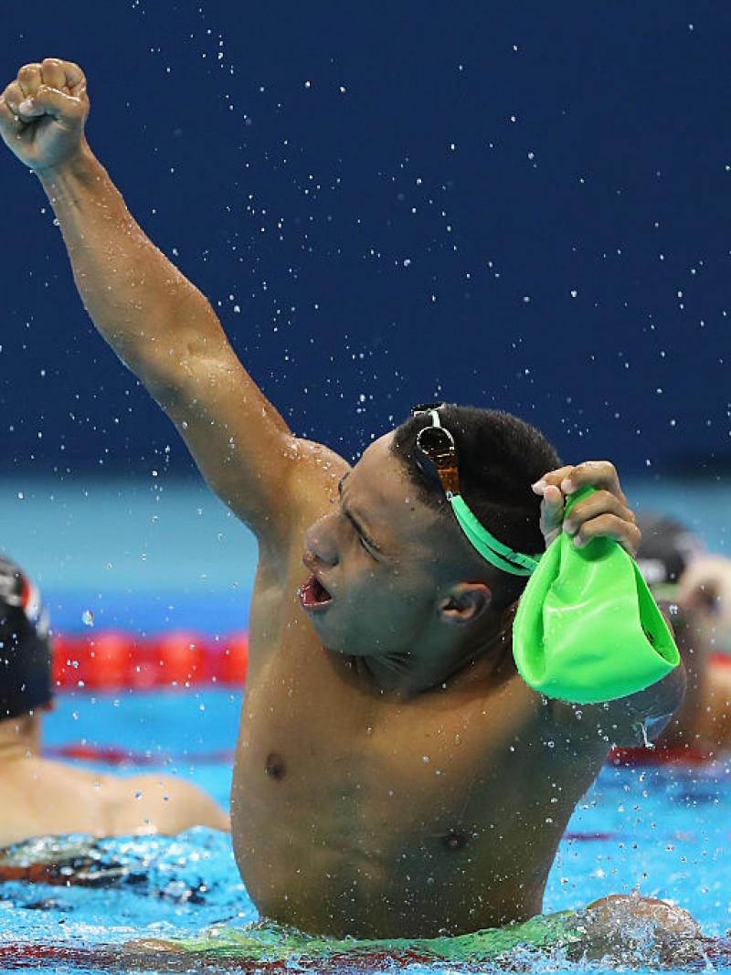 a para swimmer celebrates in the pool