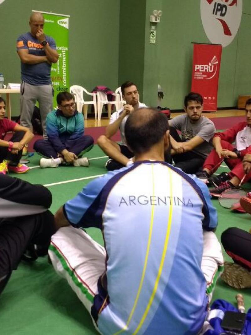 a group of para athletes sit having a group discussion