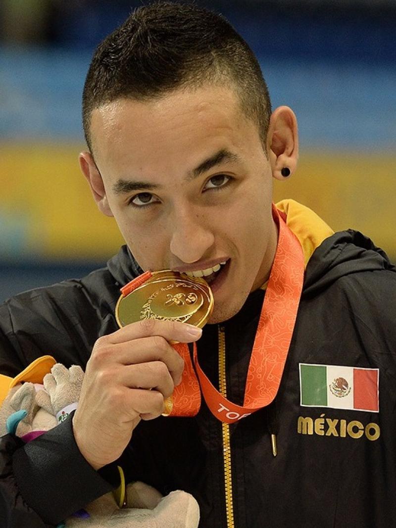 a man bites his medal on the podium