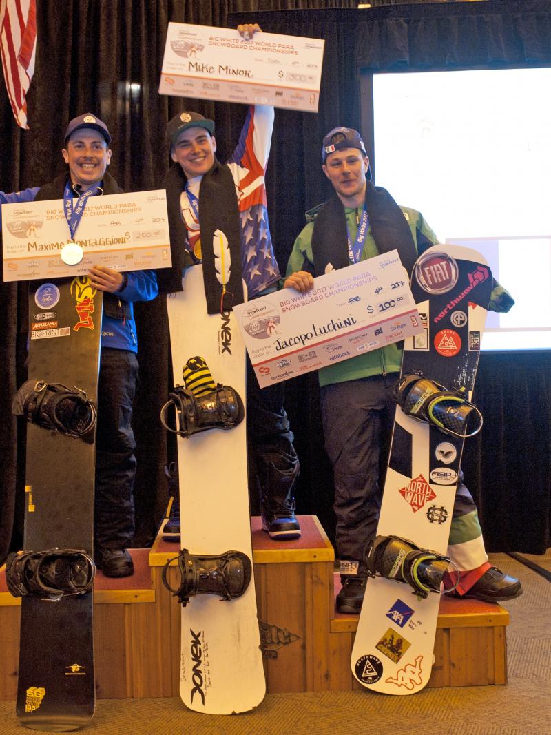 Three male snowboarders on the podium