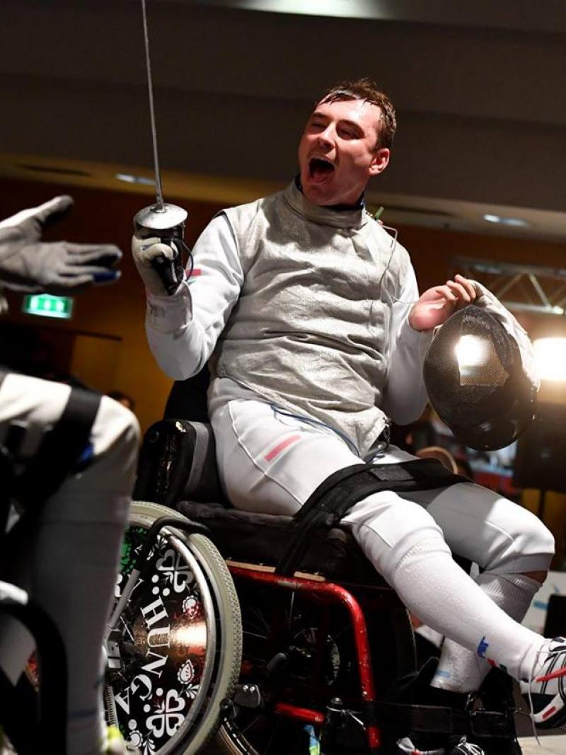 a wheelchair fencer celebrates his victory