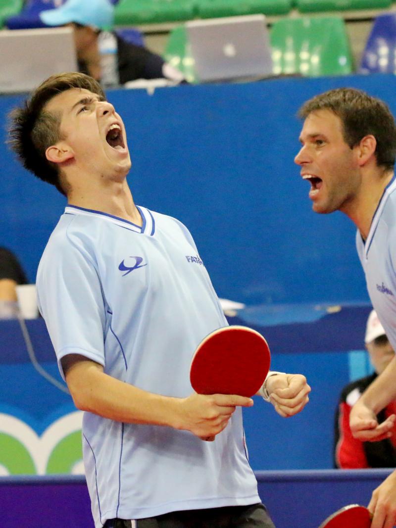 male Para table tennis players celebrate a point