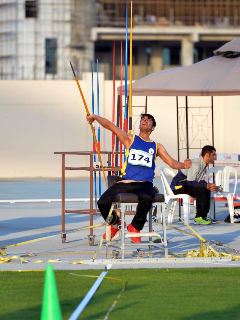 a male Para athlete throws a javelin