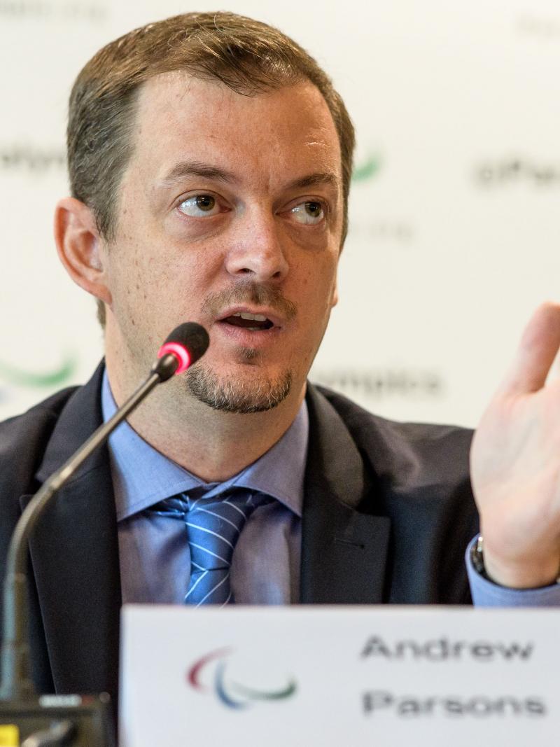 a man speaking at a desk