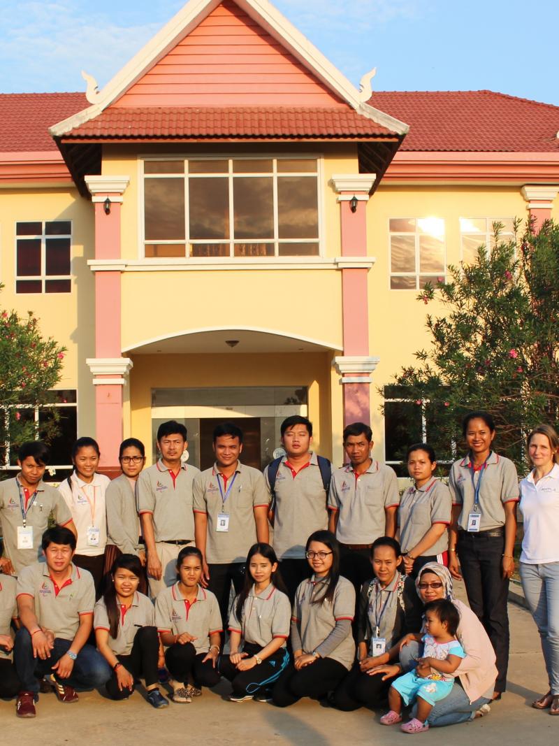 Members of NPC Cambodia and Agitos Foundation staff pose for picture in front of NPC headquarters in Phnom Penh