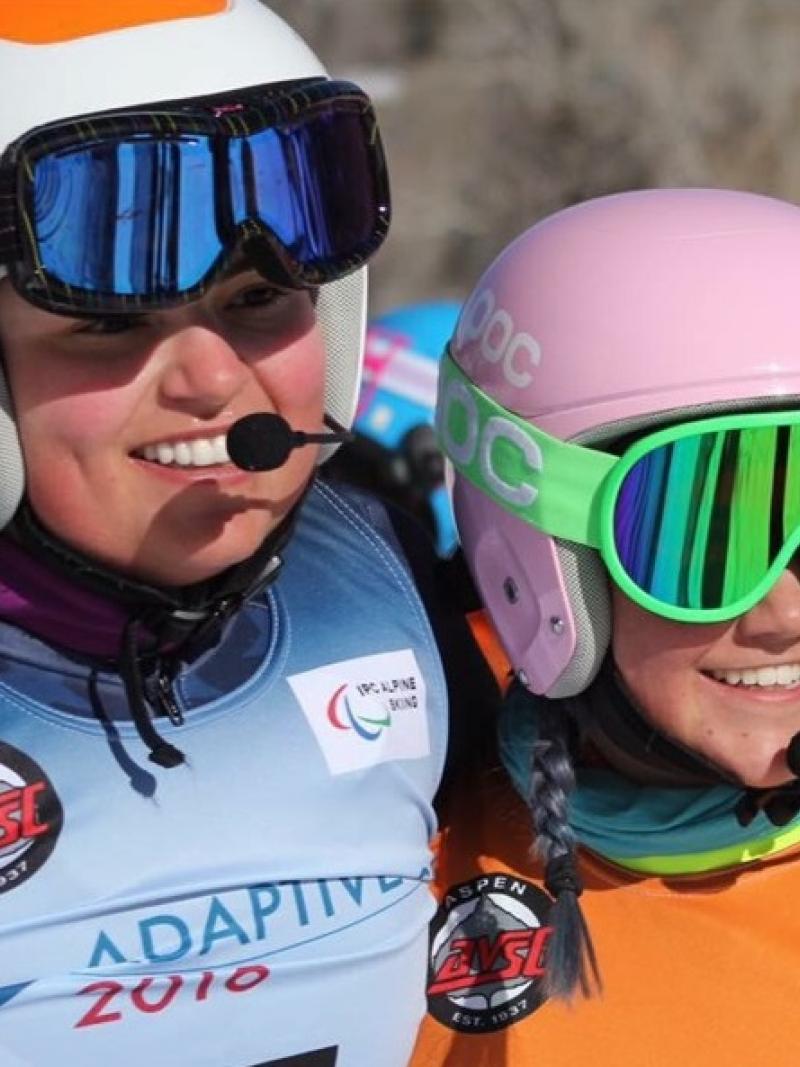 a female vision impaired skier and her guide