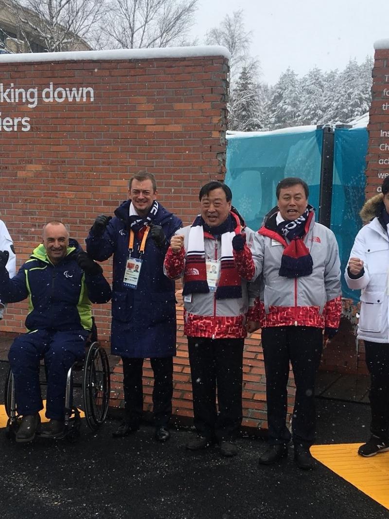 a group of people standing in front of a wall