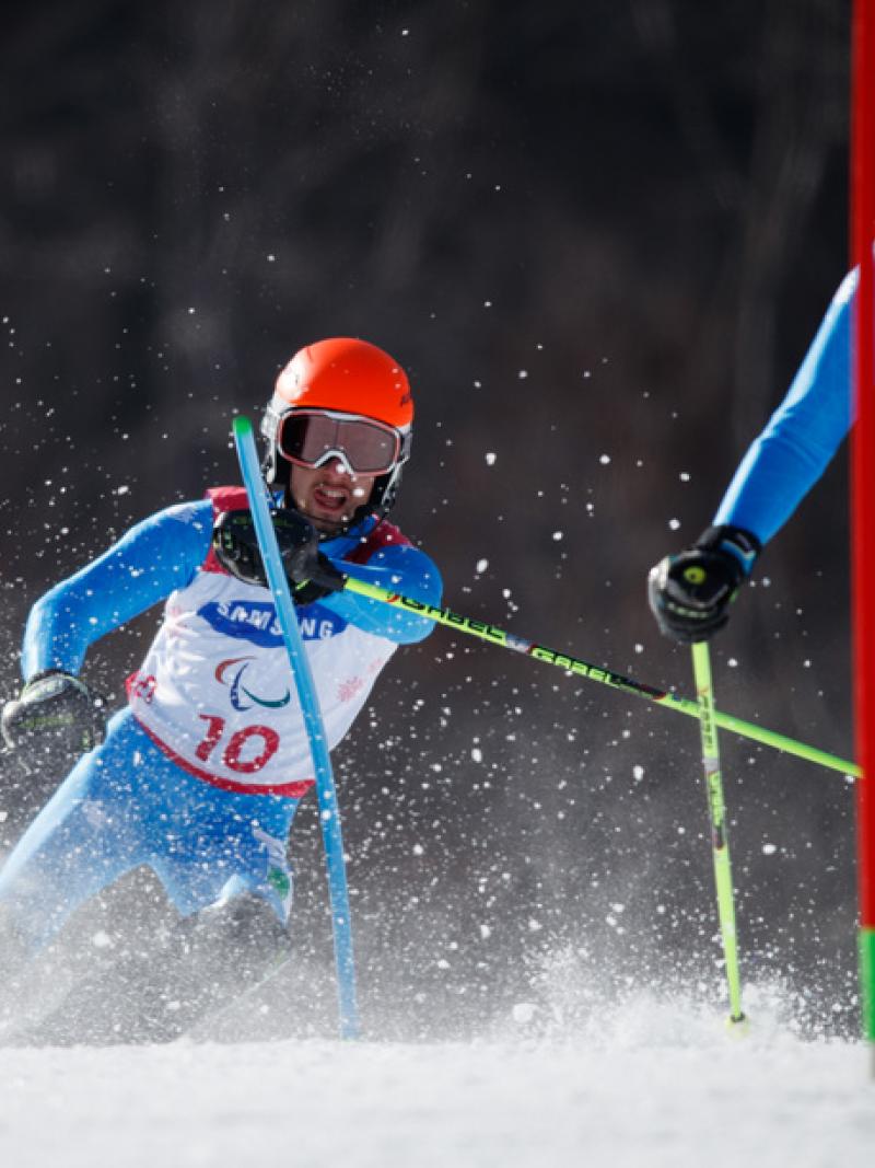 Skiier guide in front of blind skiier