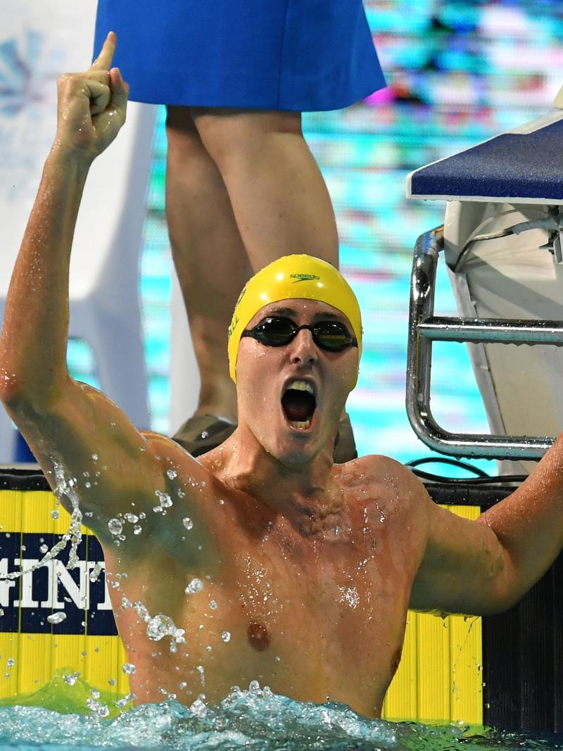 a male Para swimmer punches the air