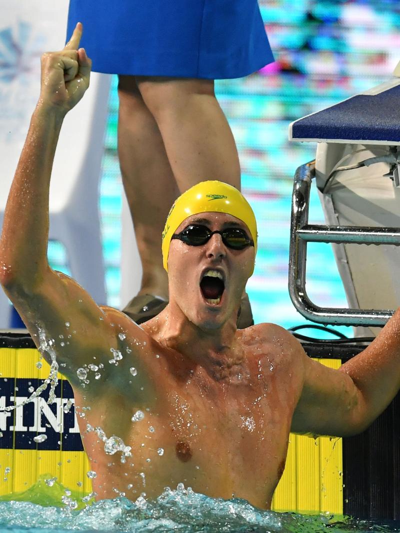 a male Para swimmer punches the air 