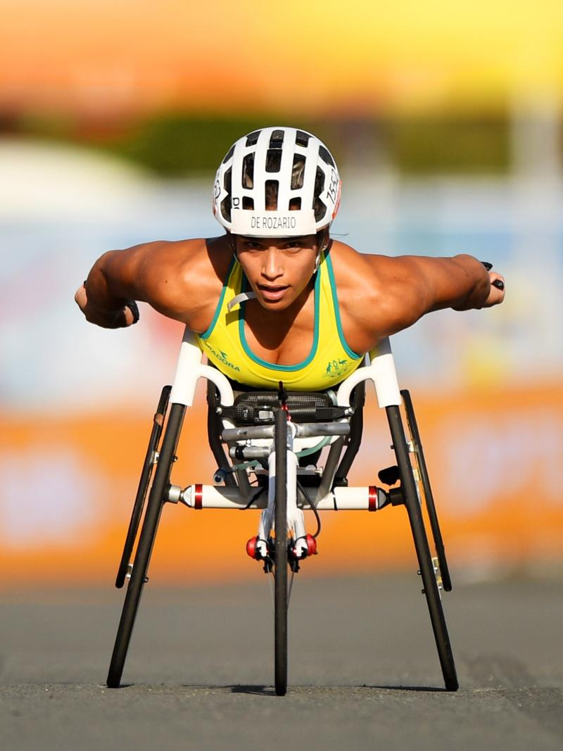 a female wheelchair racer sprints towards the line
