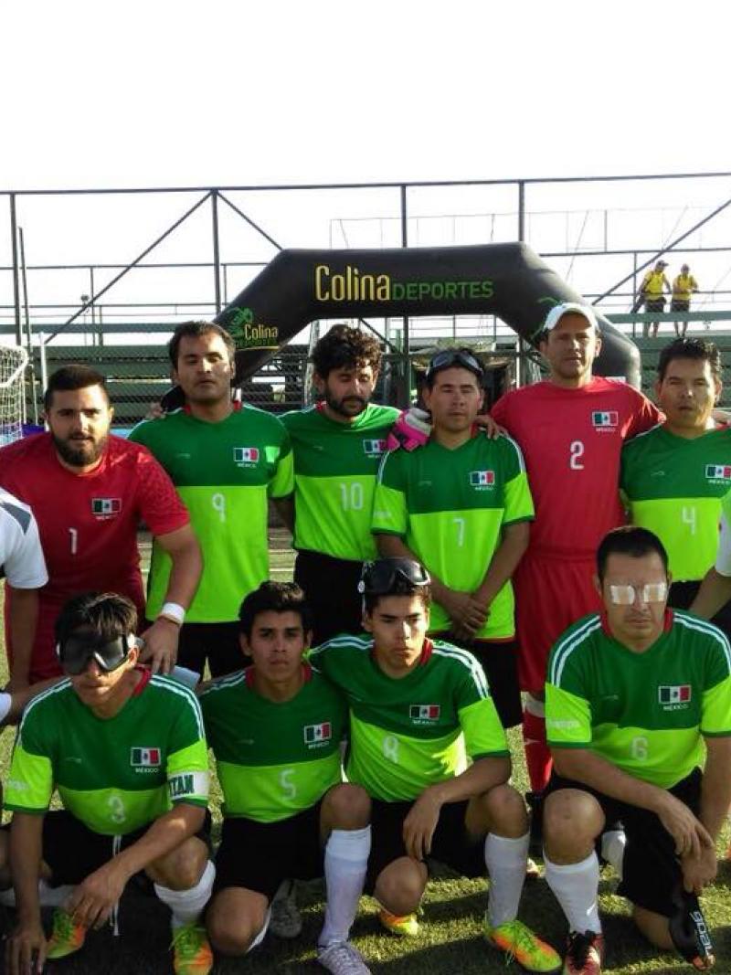 a group of blind footballers pose for a team photo