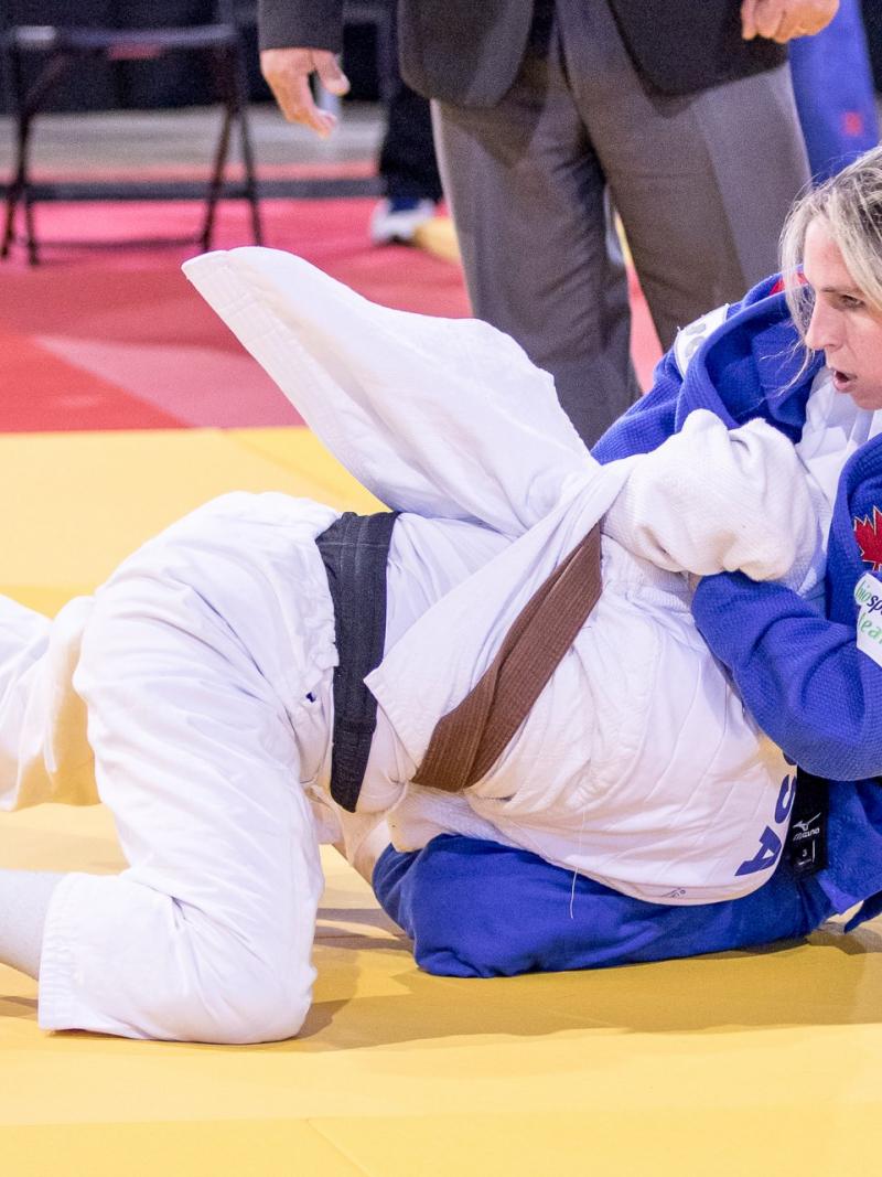 two female judokas in action on the mat