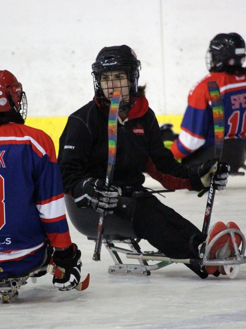 Para ice hockey athlete talks to coach during training camp in Czech Republic