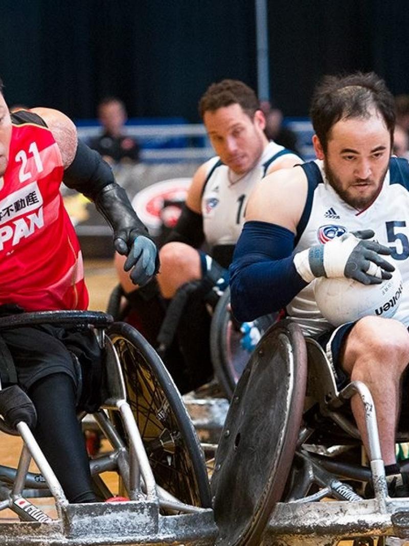 two male wheelchair rugby players clash on the court