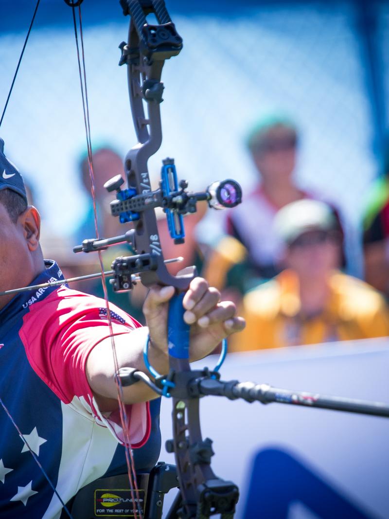male Para archer Andre Shelby prepares to shoot an arrow