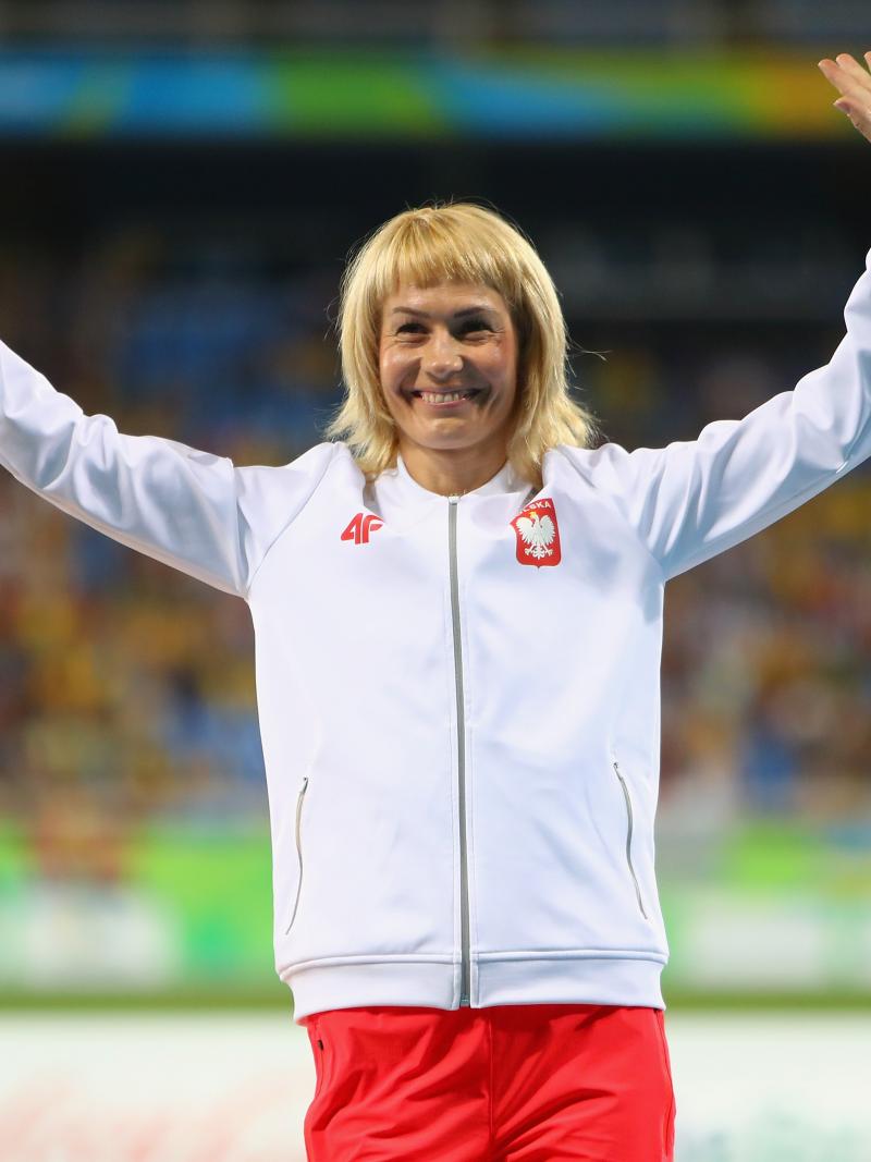 female Para sprinter Barbara Niewiedzial raises her arms on the podium