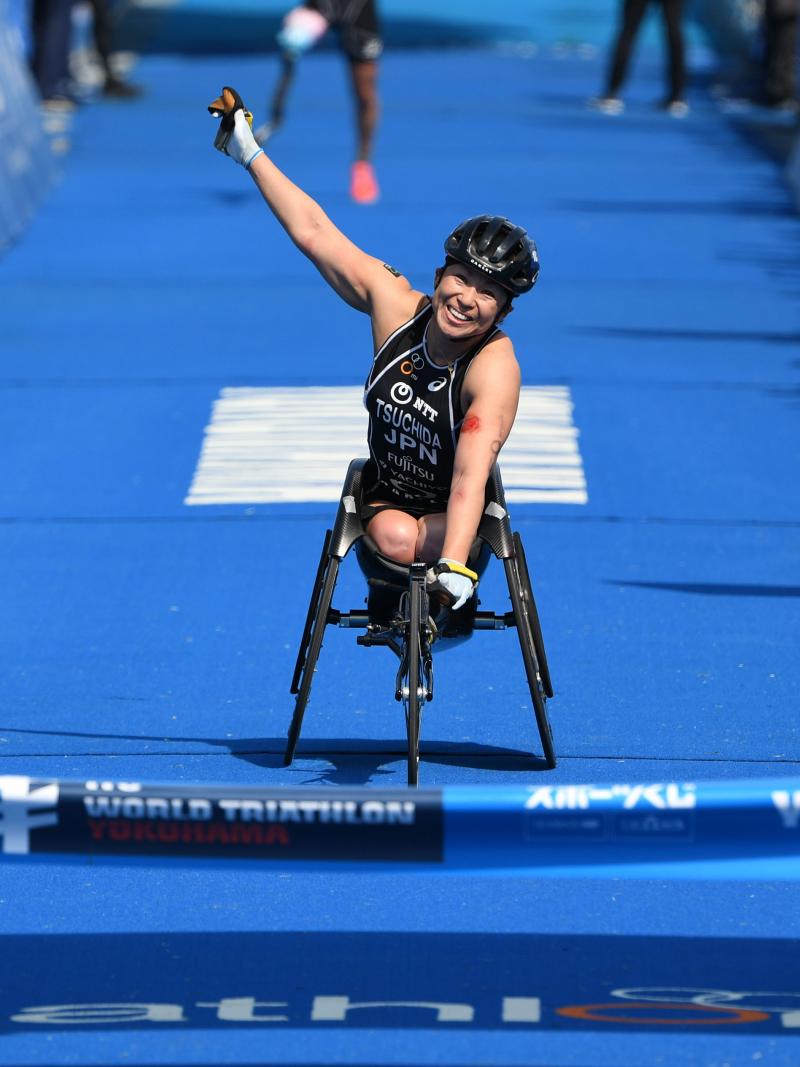 Japanese female Para triathlete Wakako Tsuchida punches the air as she crosses the finish line