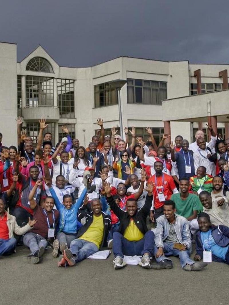 Group of people posing for a picture in front of a building