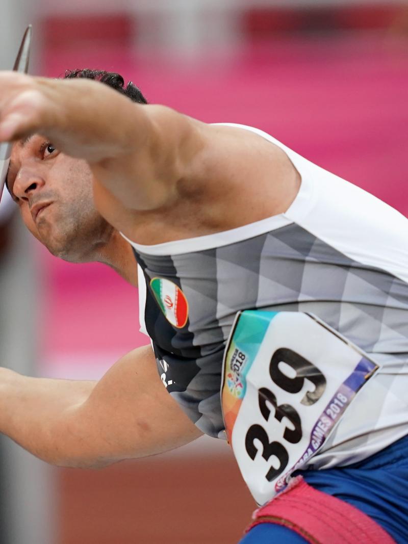 male Para athlete Amanolah Papi prepares to throw a javelin