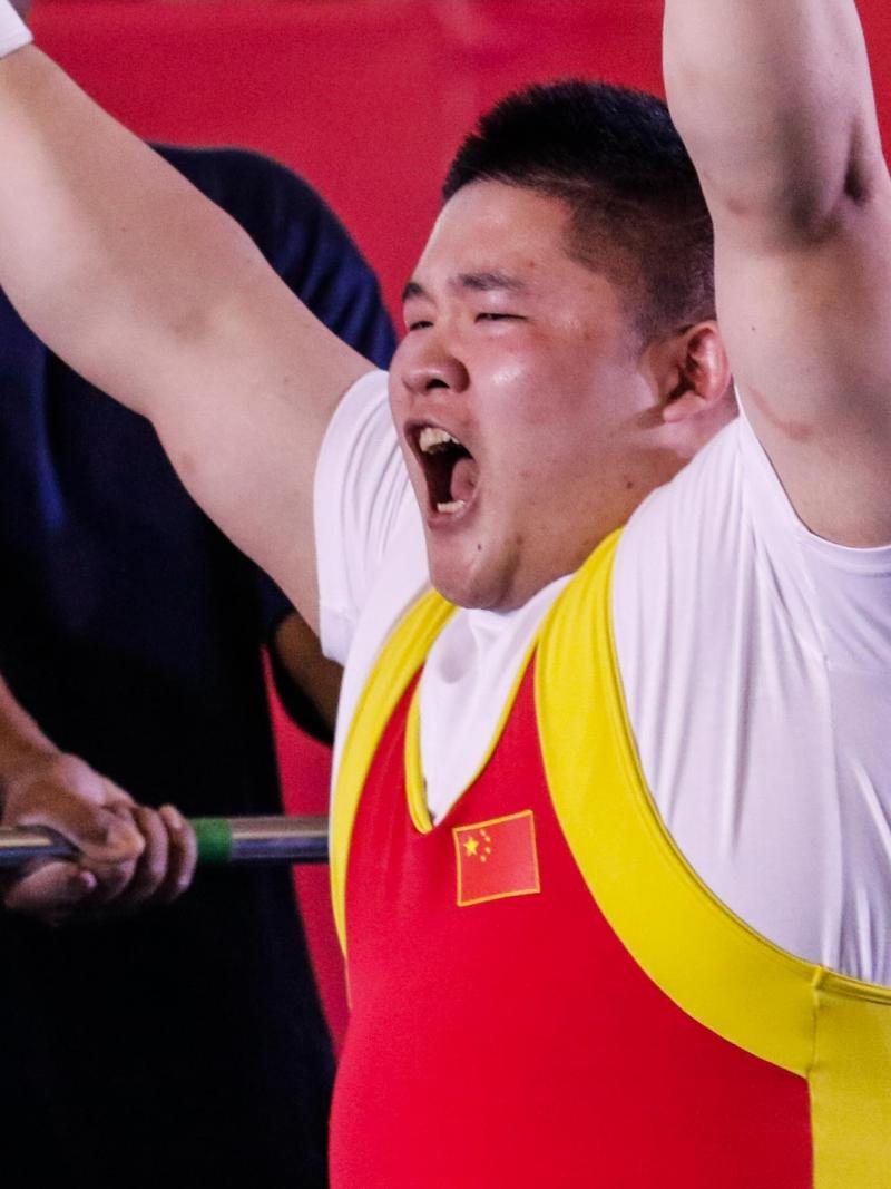 male powerlifter Jixiong Ye raises his arms in celebration
