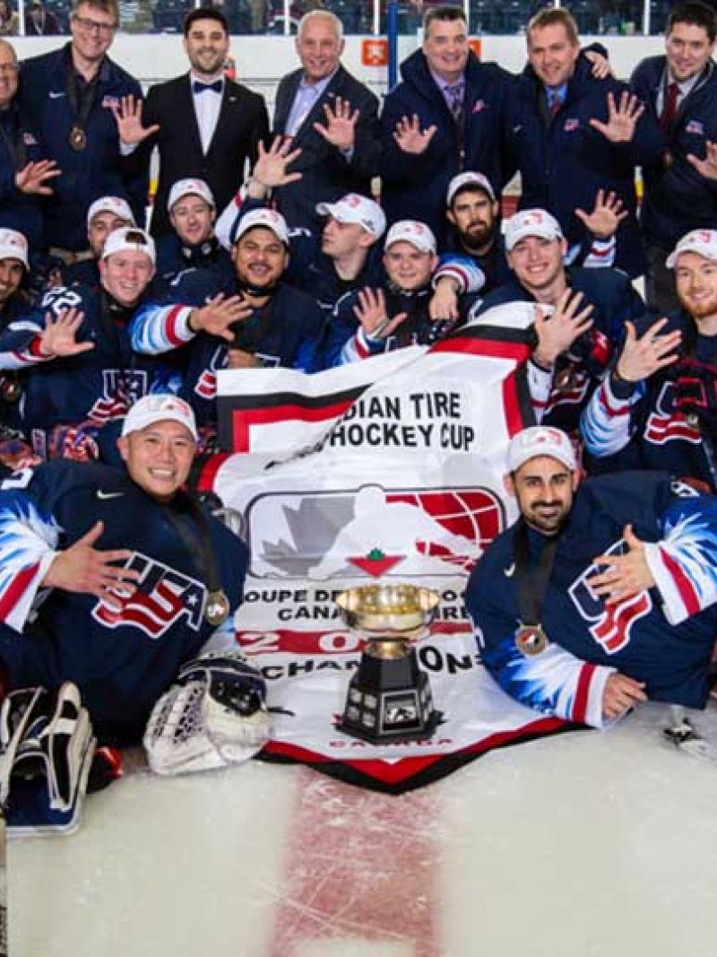 A group of Para ice hockey players celebrating on ice