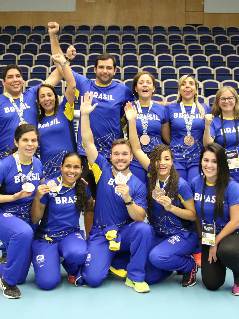 a group of female Brazilian goalballers smiling with medals round their necks