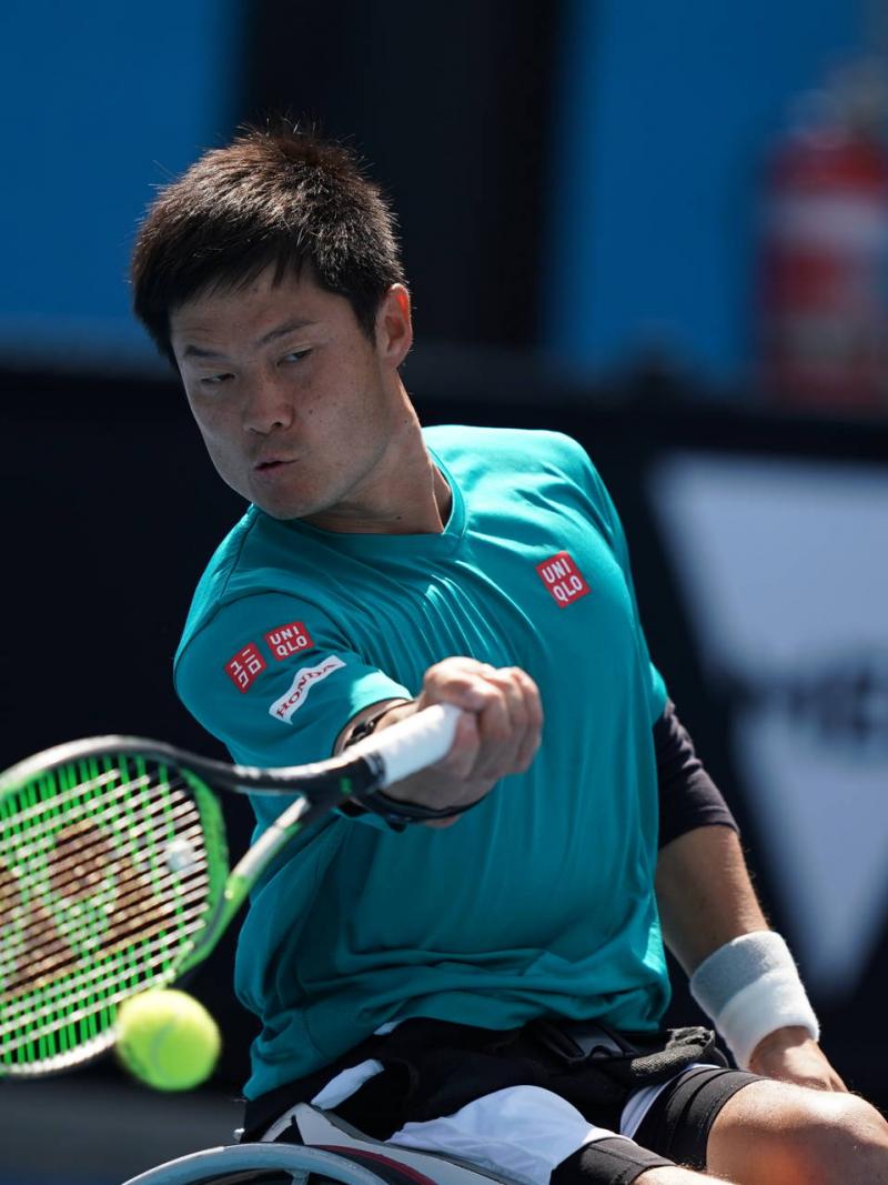 male wheelchair tennis player Shingo Kunieda plays a forehand on a hard court