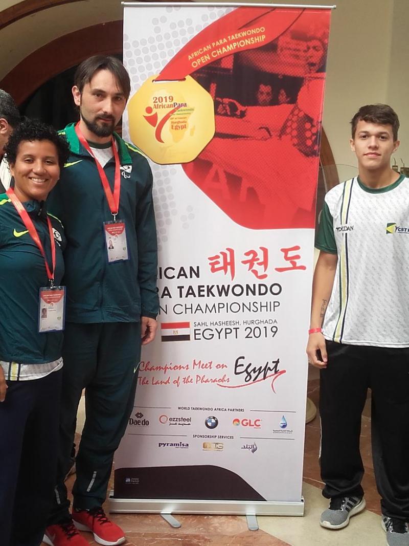 male Para taekwondo fighter Nathan Torquato stands with three other friends