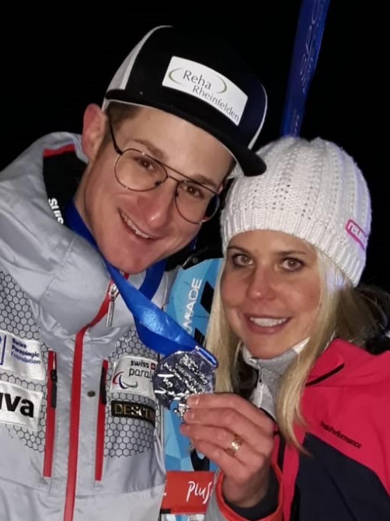 male Para alpine skier Thomas Pfyl hugs his wife Evelyn while both smile