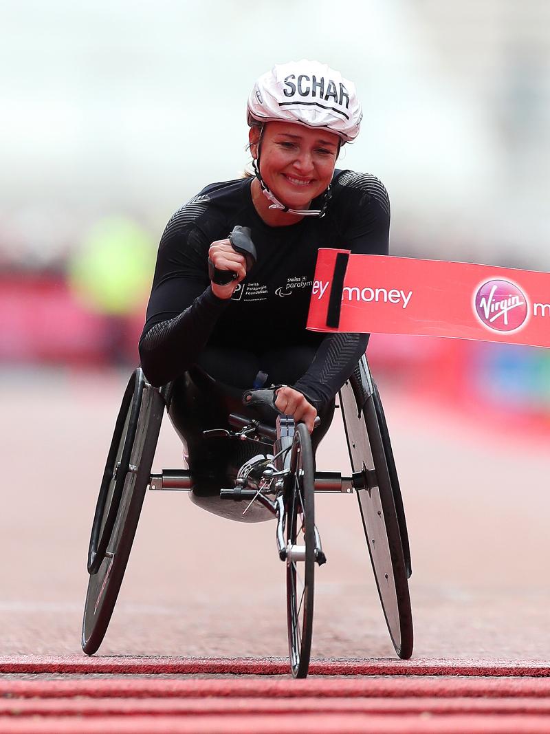 Female wheelchair racer Manuela Schaer breaks the tape at the finish line