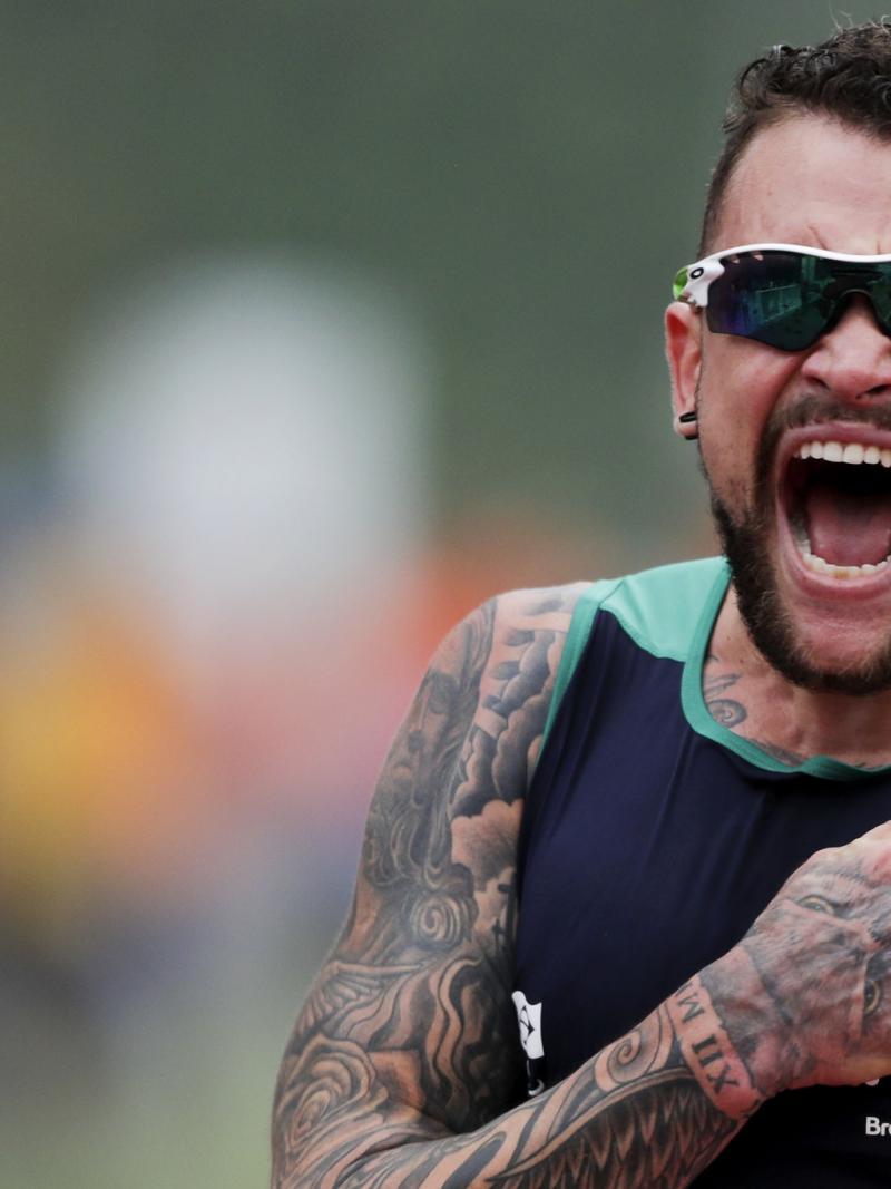 male Para athlete Vinicius Rodrigues beats his chest and screams in celebration