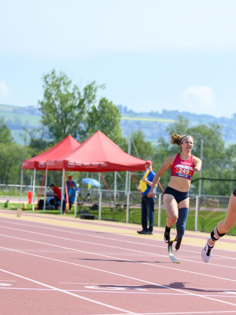 German female sprinter leads ahead of three other runners