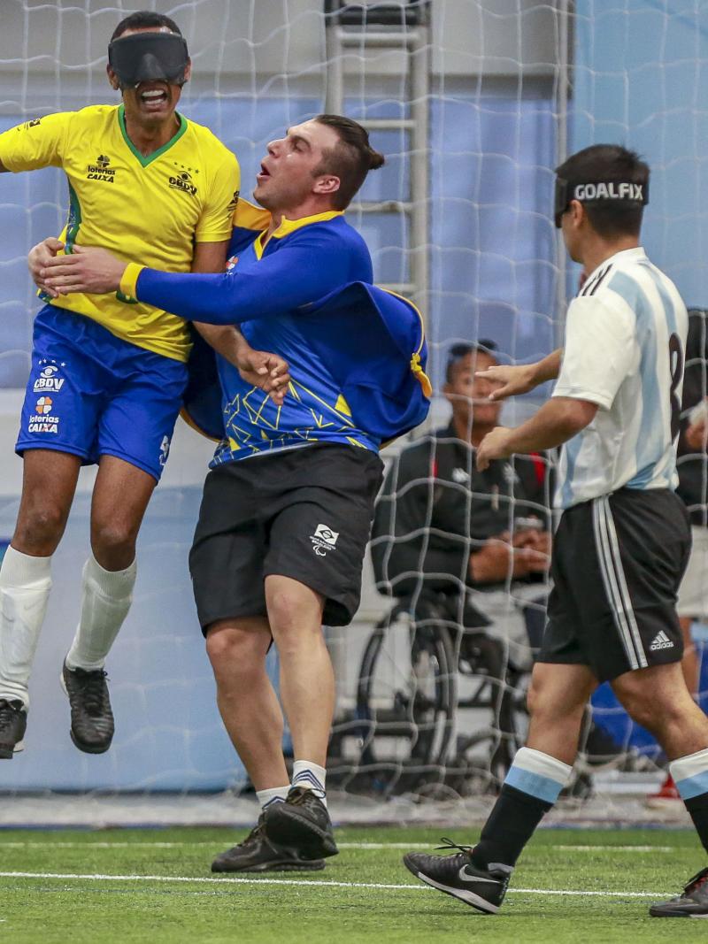 Raimundo Nonato jumps and celebrates his goal while Argentinian defender express sadness