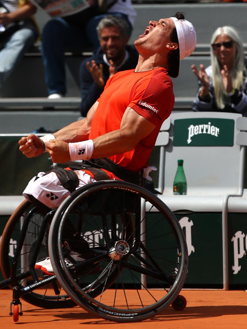 Argentinian wheelchair tennis player Gustavo Fernandez celebrates screaming at the sky after winning Roland Garros