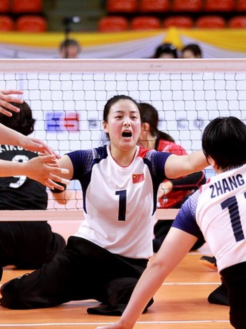 Chinese female sitting volleyball players celebrate a point