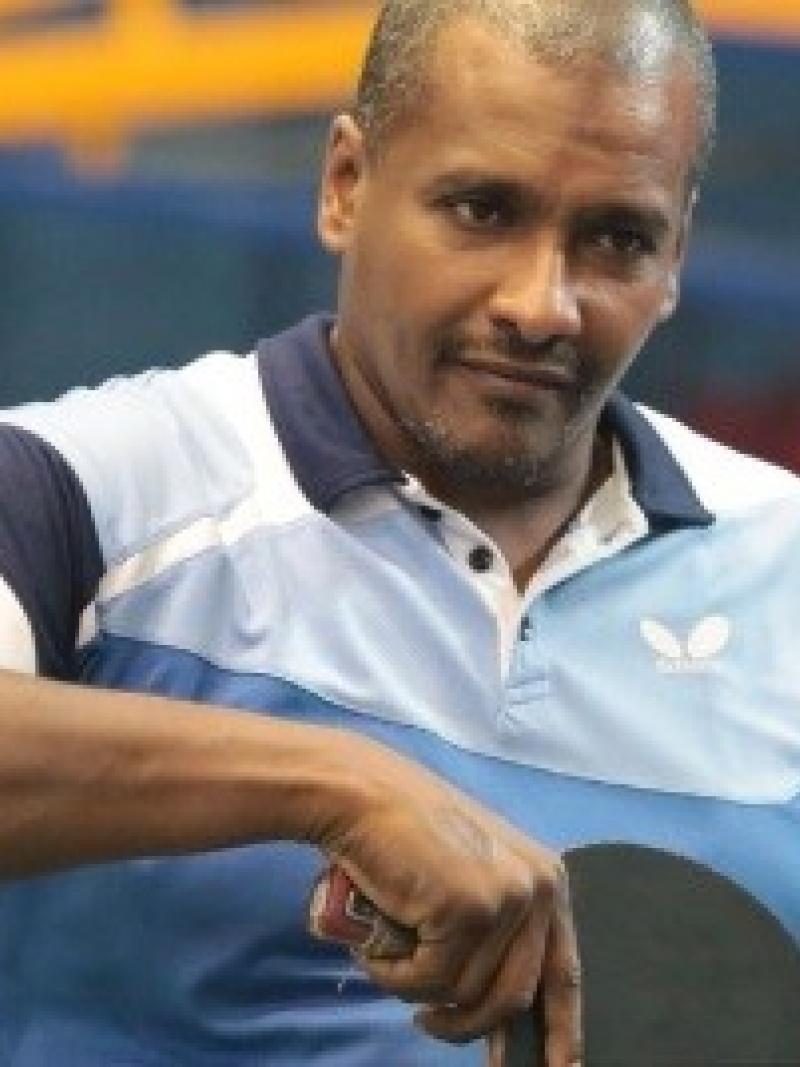 Egyptian male table tennis player about to hit the ball with his racquet