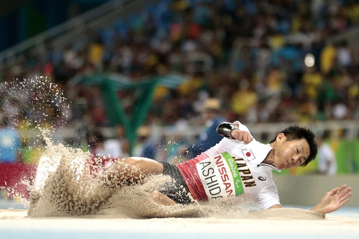 Japanese man completes long jump in sand