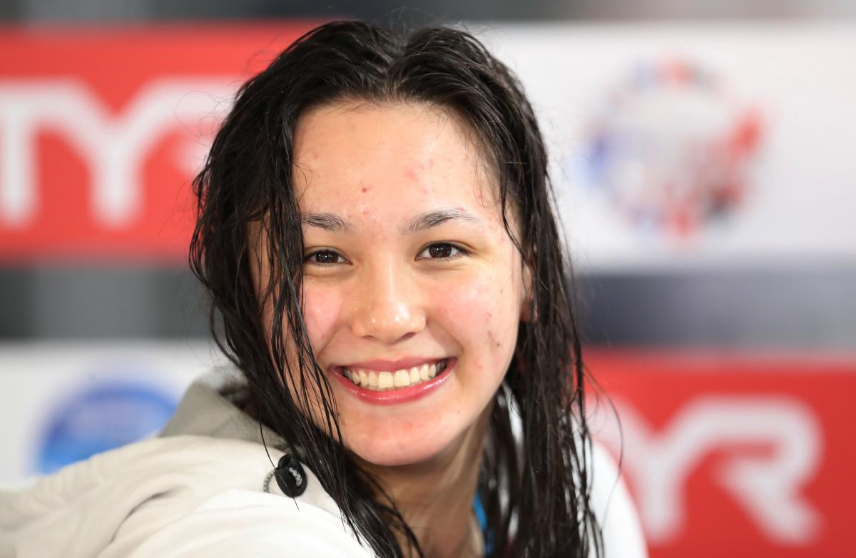 a female Para swimmer smiling