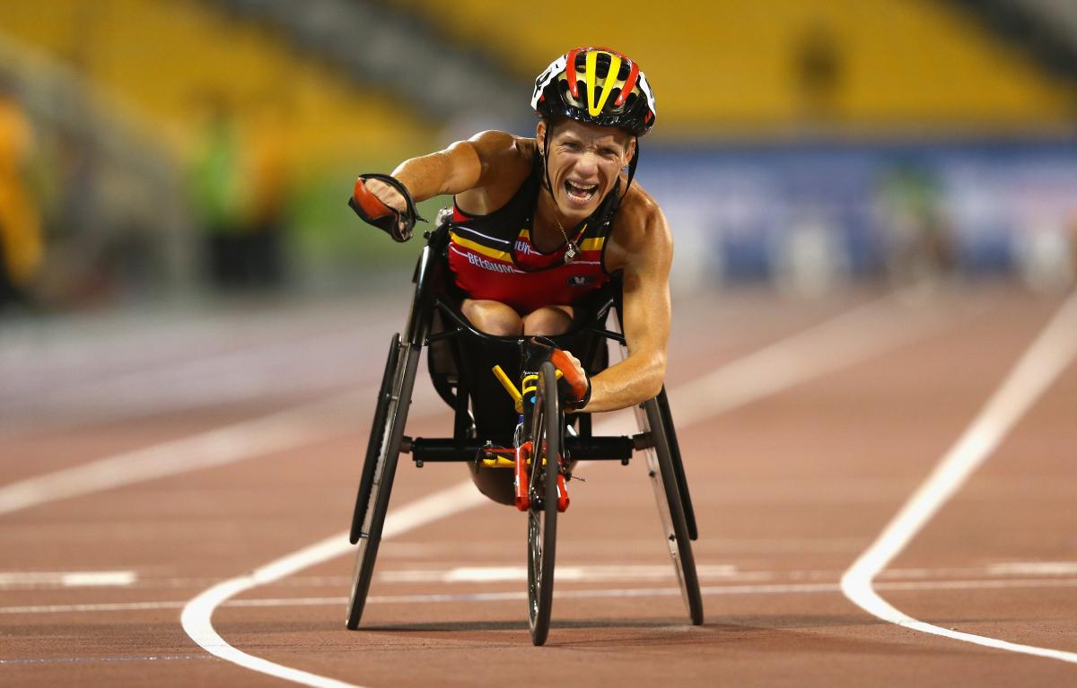 Marieke Vervoort celebrates as she crosses the finish line