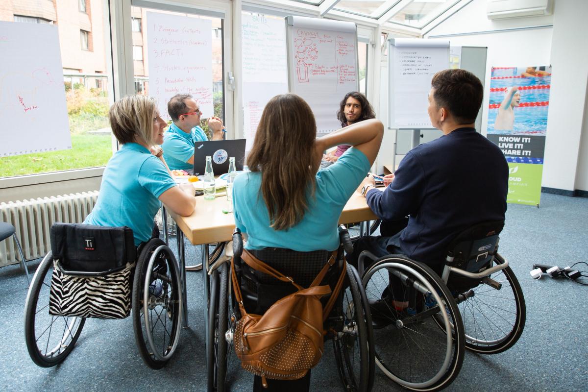 Five Proud Paralympian Educators work in group during a course in Bonn