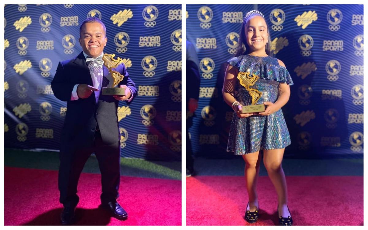 Herbert Aceituno and Sara Vargas hold their trophies