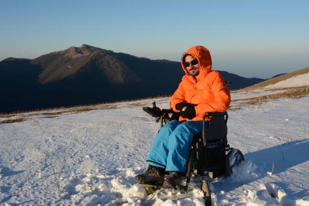 A man in an electric wheelchair on the snow