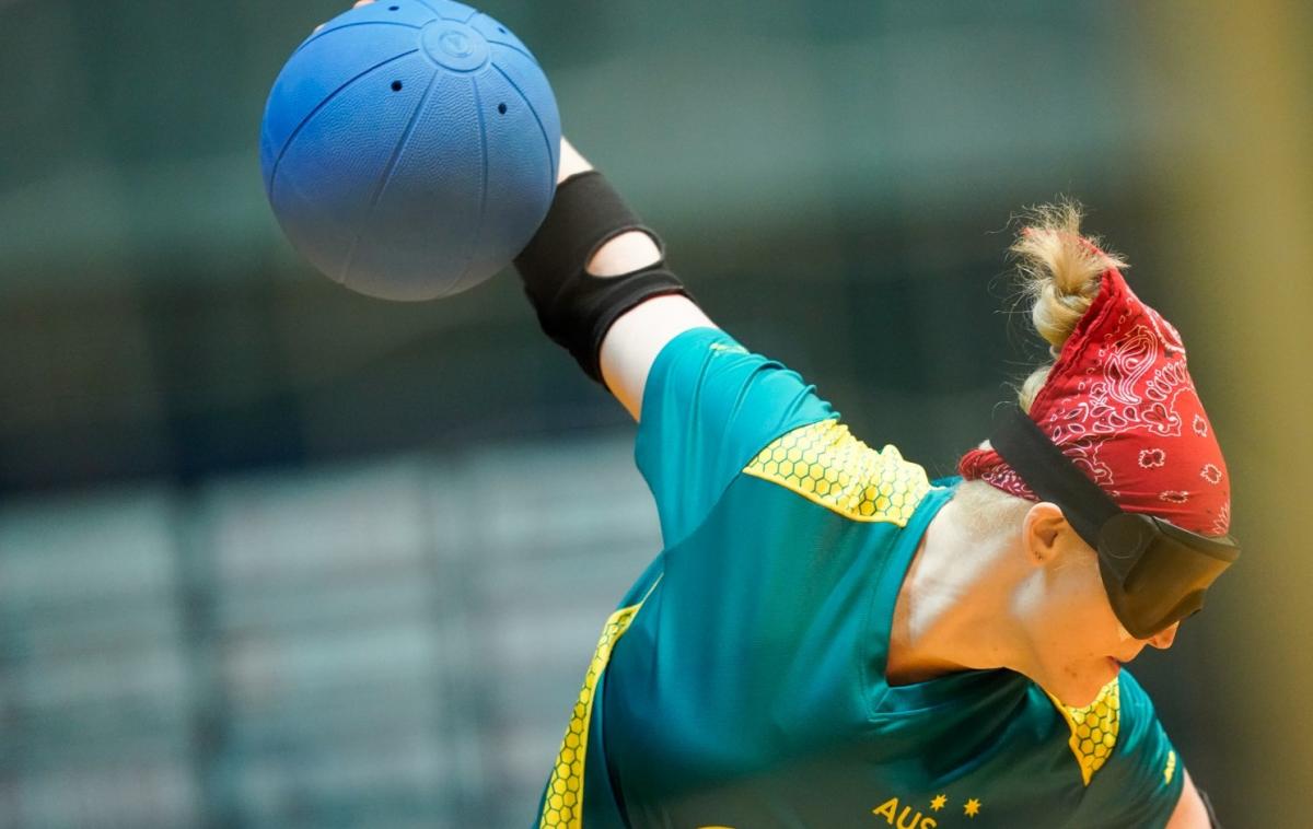 Female goalball player winds up to throw the ball