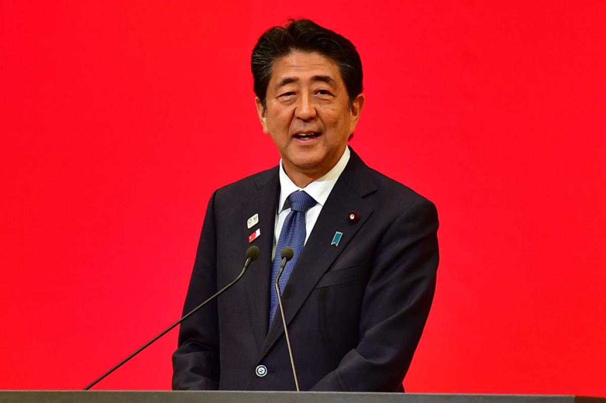 Photo of Japanese male Prime Minister speaking on podium