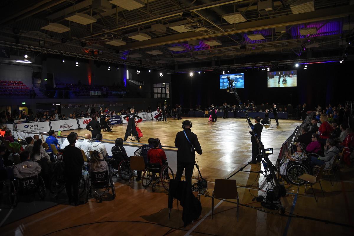 An external view of a Para dance sport venue with five couples competing